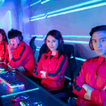 Pro player Indonesia dari tim esports ternama sedang berpose di panggung turnamen internasional dengan seragam merah khas tim.